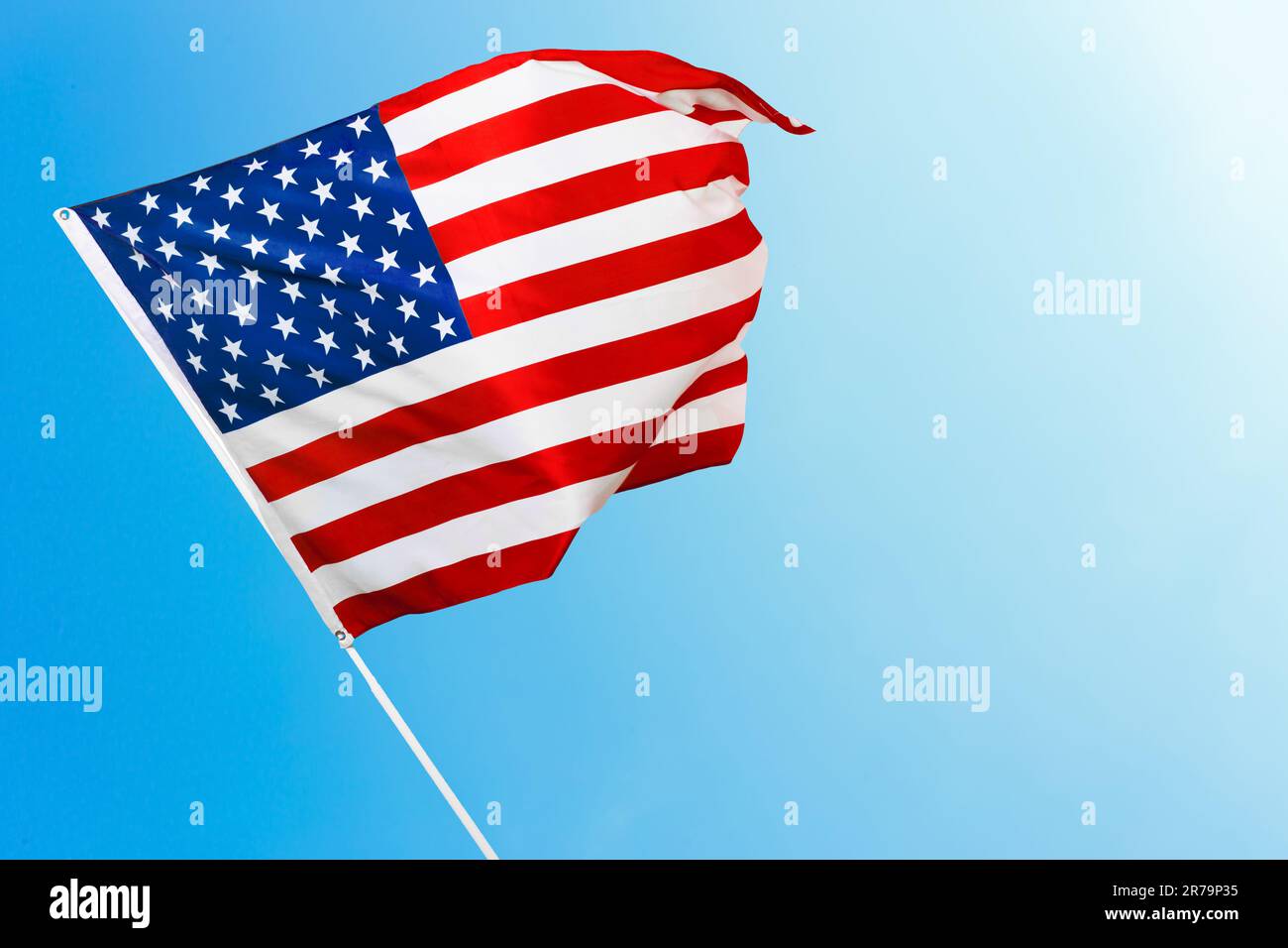 American flag against blue sky Stock Photo - Alamy