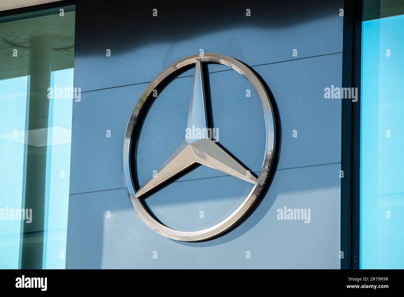 Logo of Mercedes-Benz on a car dealership Stock Photo