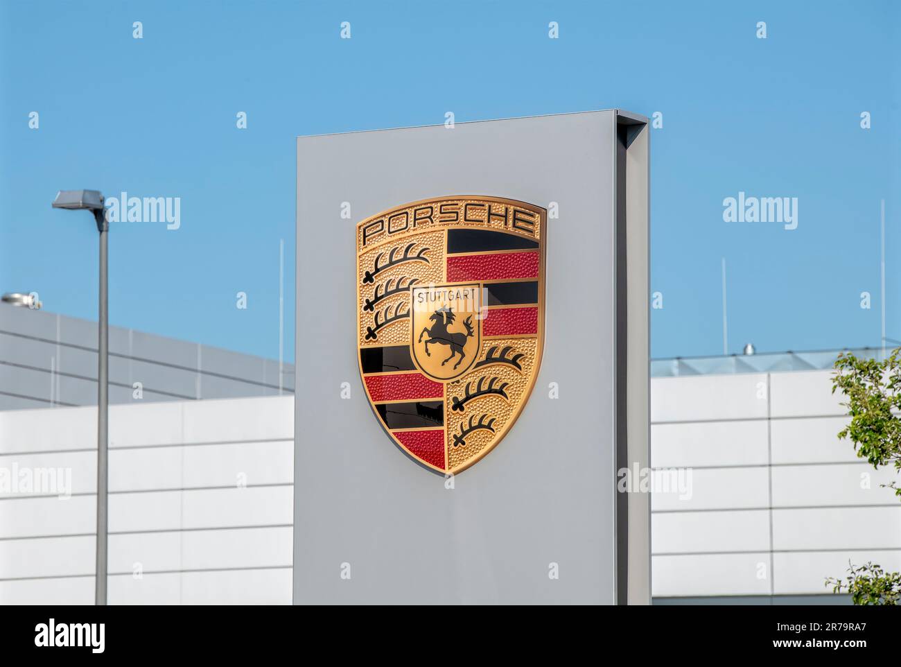 Logo of the car manufacturer Porsche on a car dealership Stock Photo