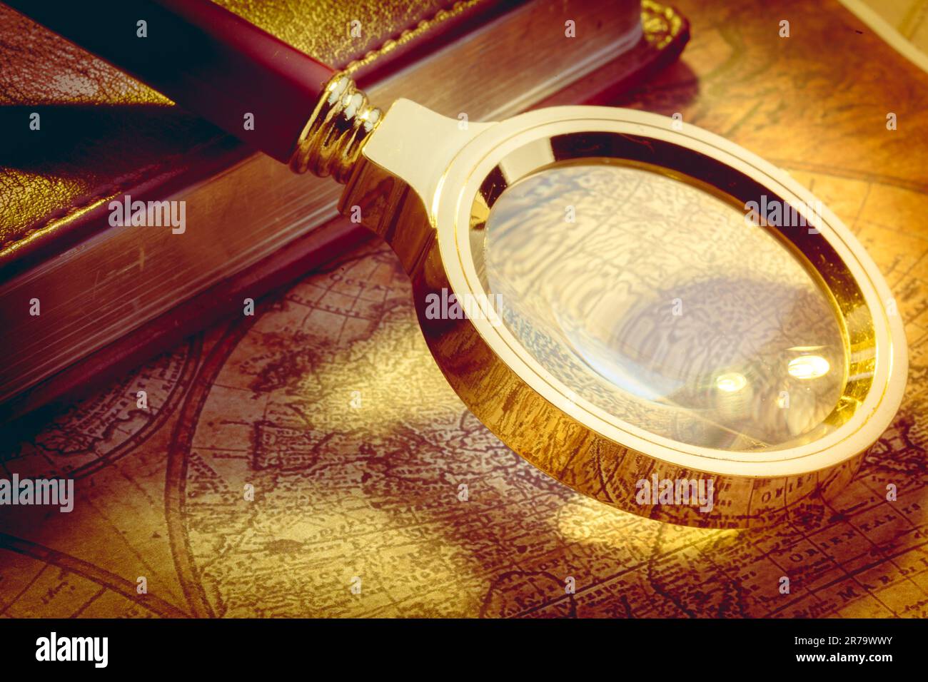 Old map with an magnifying glass Stock Photo - Alamy