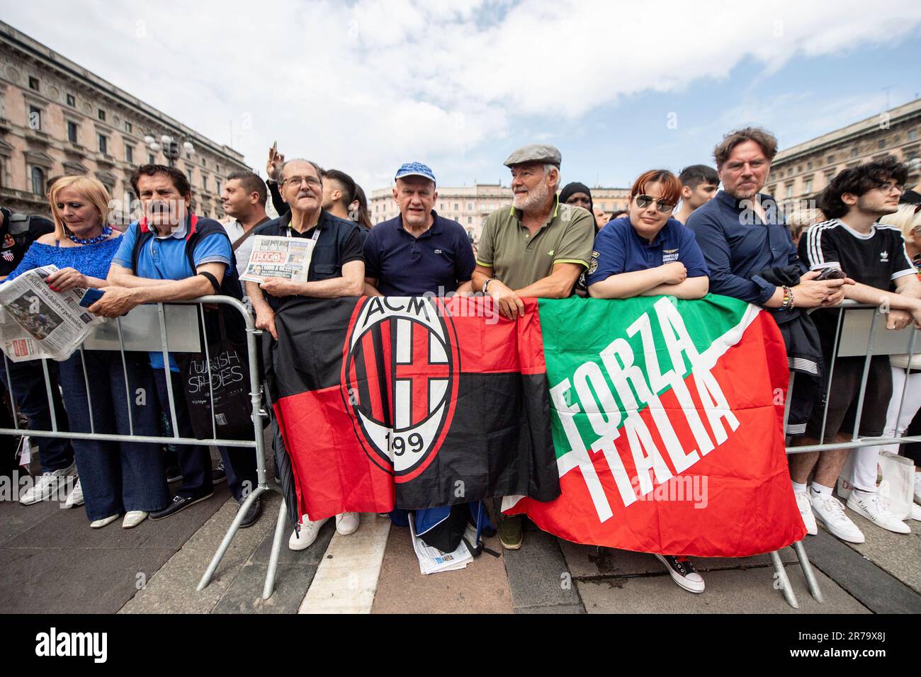 People with AC Milan soccer team and Forza Italia party flags gather in  front of Milan's Gothic Cathedral ahead of former Italian premier Silvio  Berlusconi's funeral, Italy, Wednesday, June 14, 2023. Berlusconi'