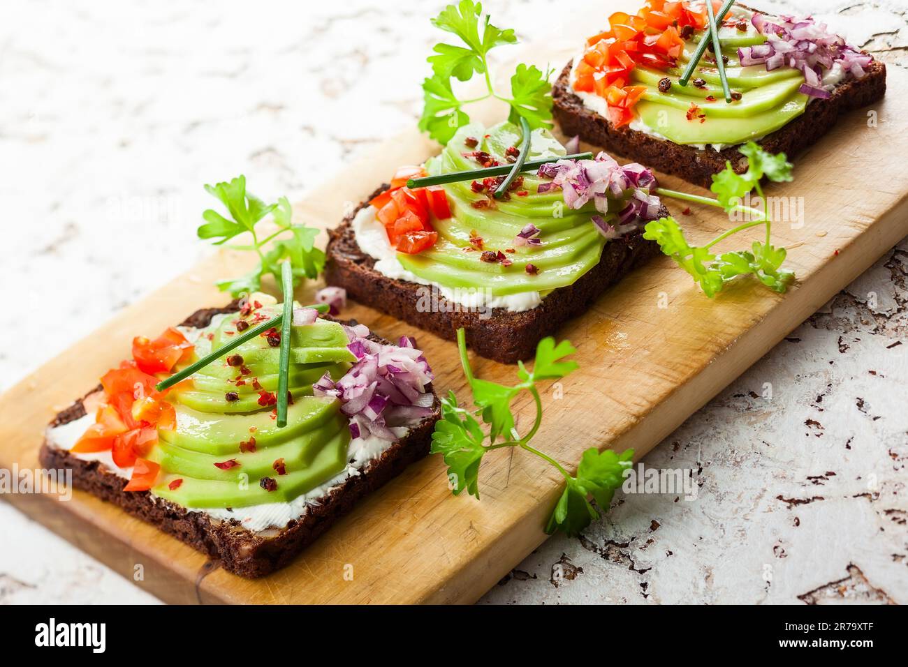 fresh-vegetarian-open-sandwiches-on-black-bread-with-avocado-tomato