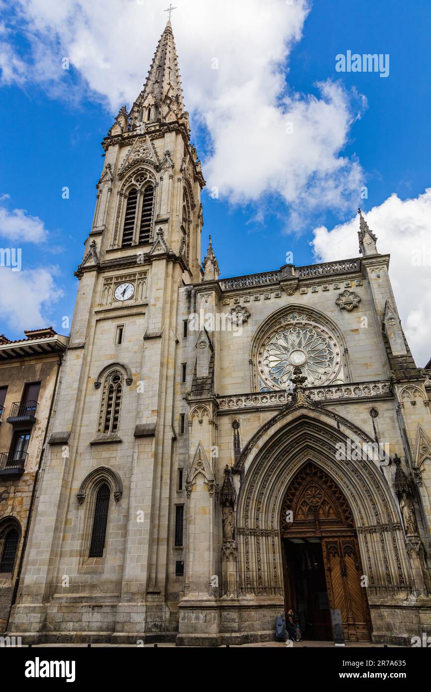 Bilbao Cathedral main facade and spire in Gothic Revival style with intricate stonework and ornate details. Bilbao, Basque Country, Spain. Stock Photo