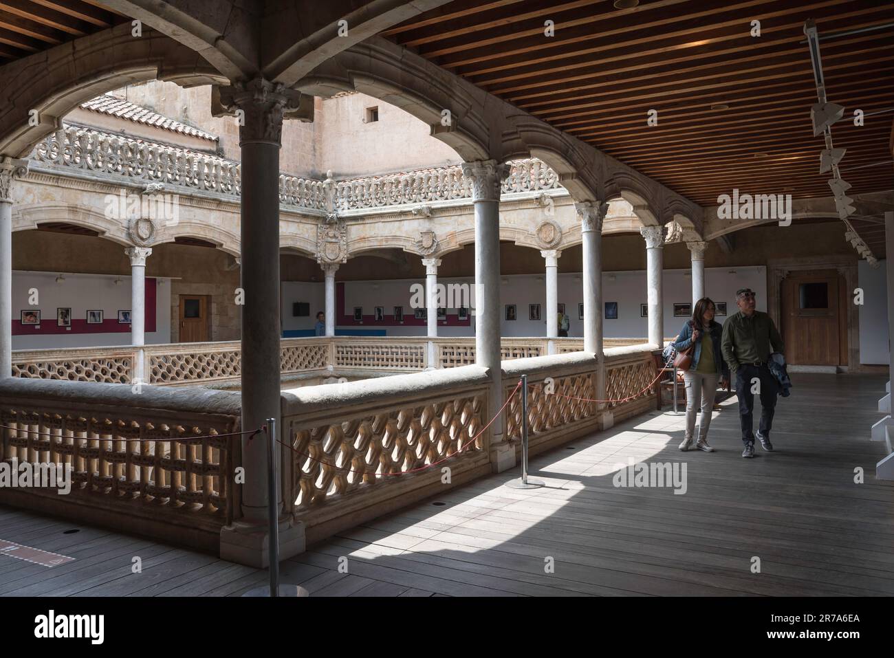 Renaissance arcade Spain, view of a middle aged couple exploring the upper gallery inside the renaissance-era Casa de las Conchas, Salamanca, Spain Stock Photo