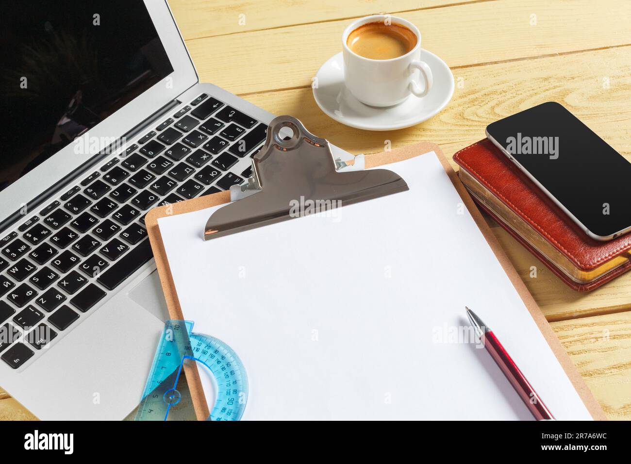 Office table background with coffee cup, pencils and computer keyboard