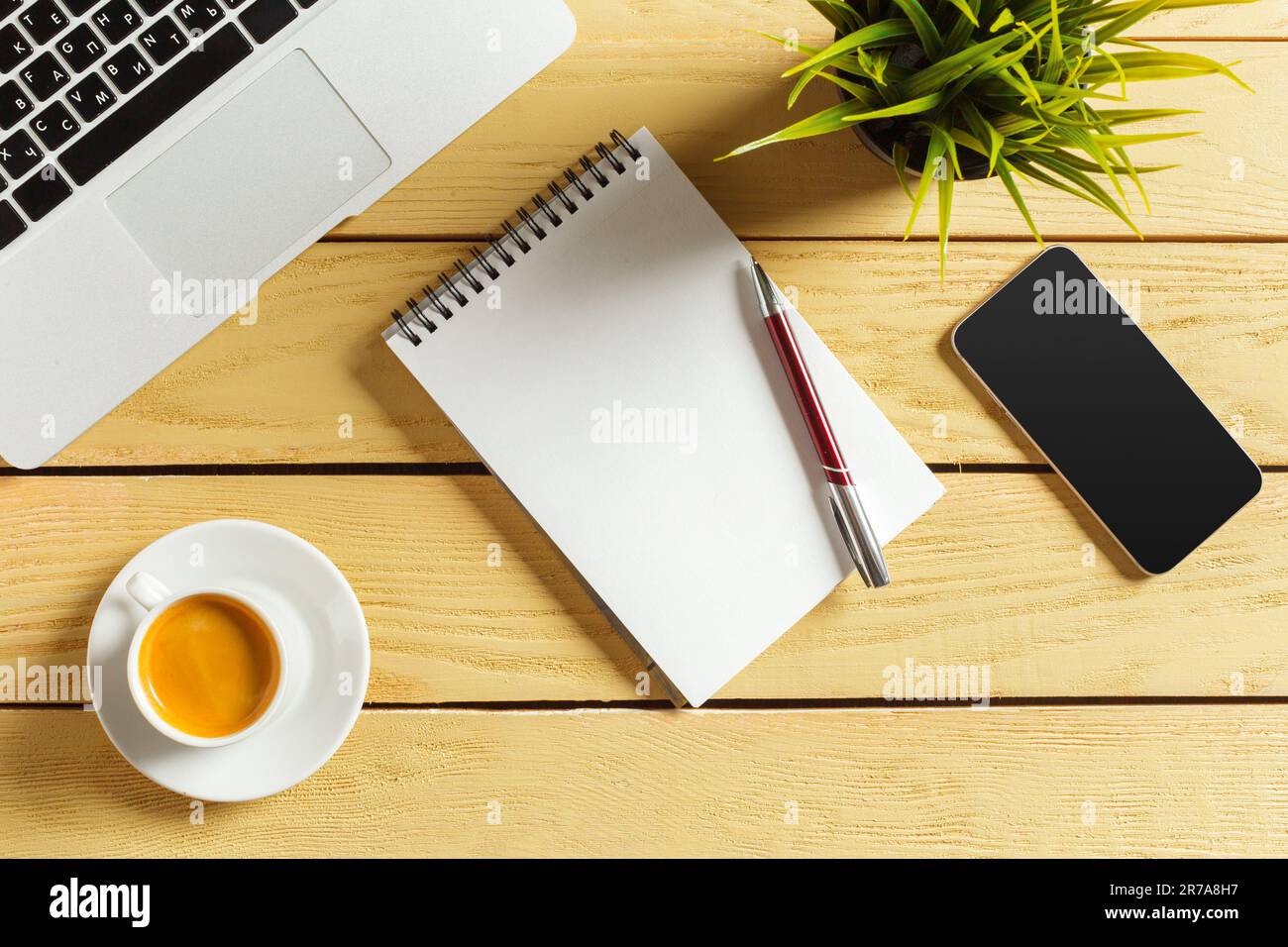 Office table background with coffee cup, pencils and computer keyboard