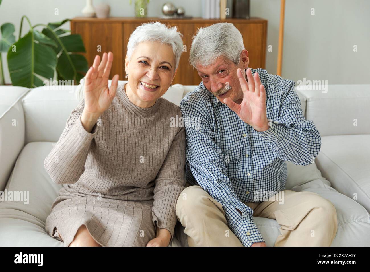 Happy senior woman man talk on video call with friends family. Mature old  grandmother grandfather talking speaking with grown up children online.  Older generation modern tech usage. Webcamera view Stock Photo -