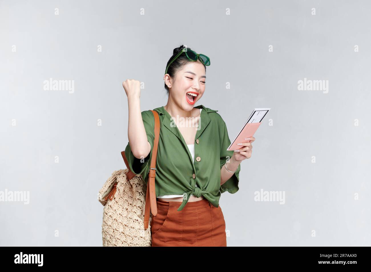 Traveler fun woman wear casual clothes hold passport ticket do winner gesture Stock Photo