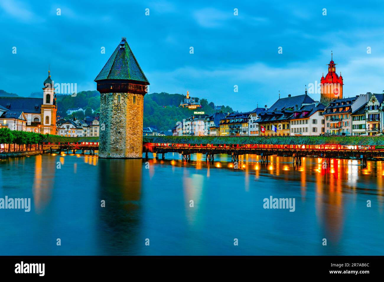 Beautiful historic city of Lucerne with famous Chapel Bridge and Water Tower at twilight time , Switzerland Stock Photo