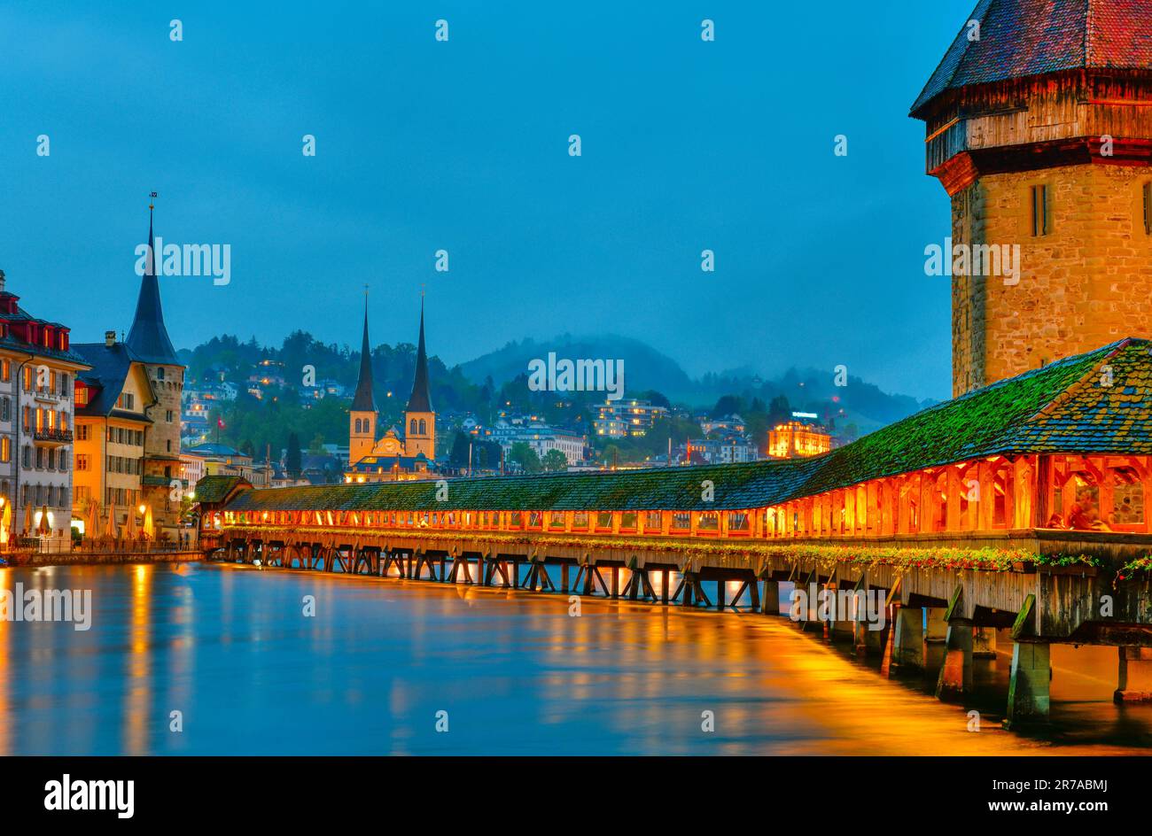 Beautiful historic city of Lucerne with famous Chapel Bridge and Water Tower at twilight time , Switzerland Stock Photo