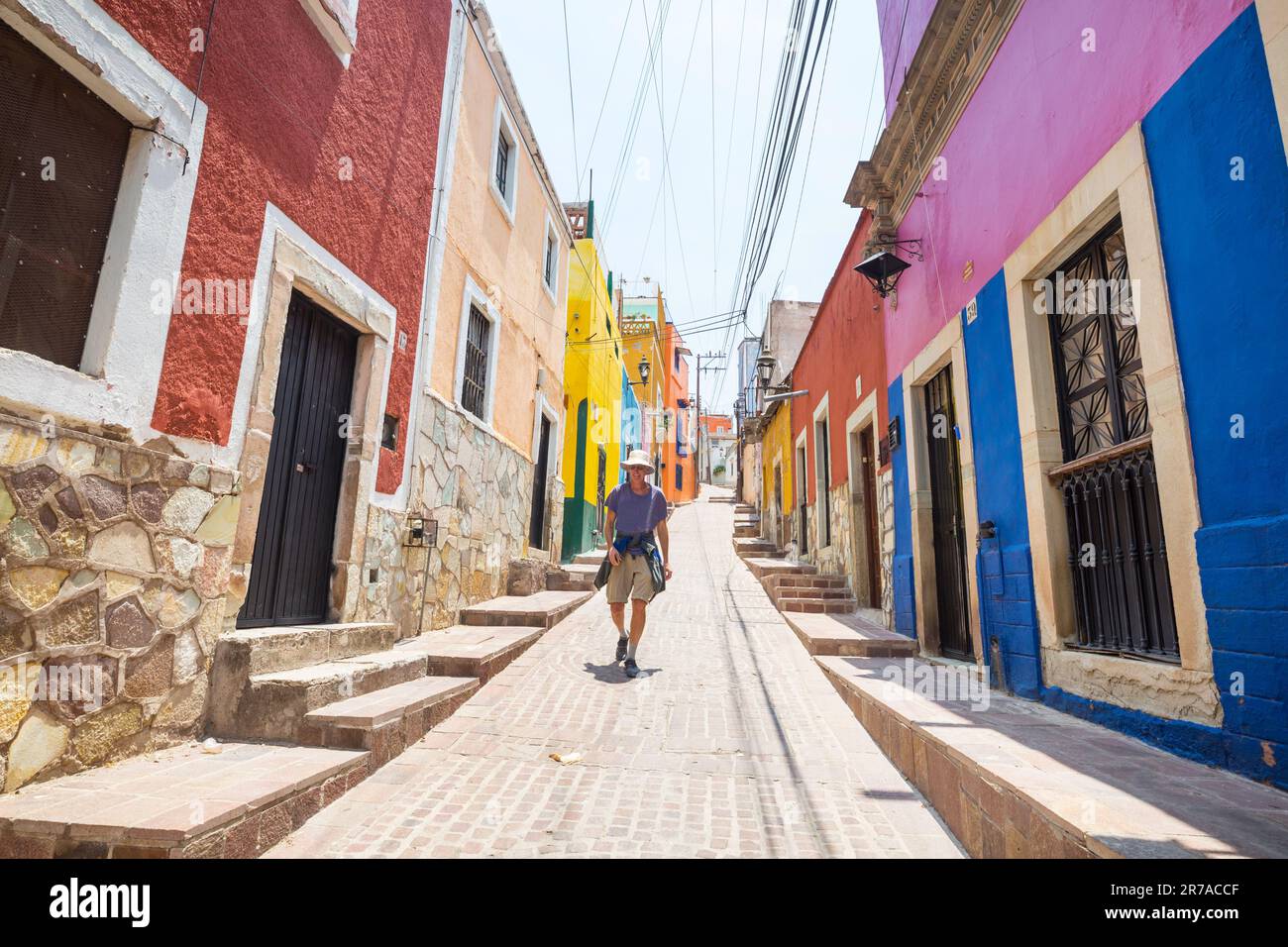 Tourist on colorful street in the famous city of Guanajuato, Mexico Stock Photo