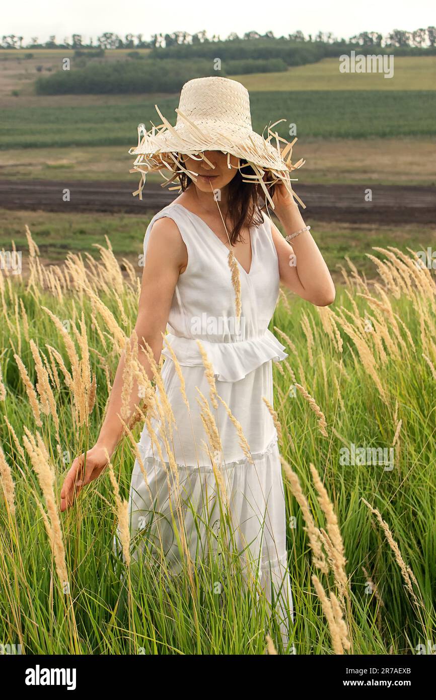 Woman walks across field hand hi-res stock photography and images - Alamy