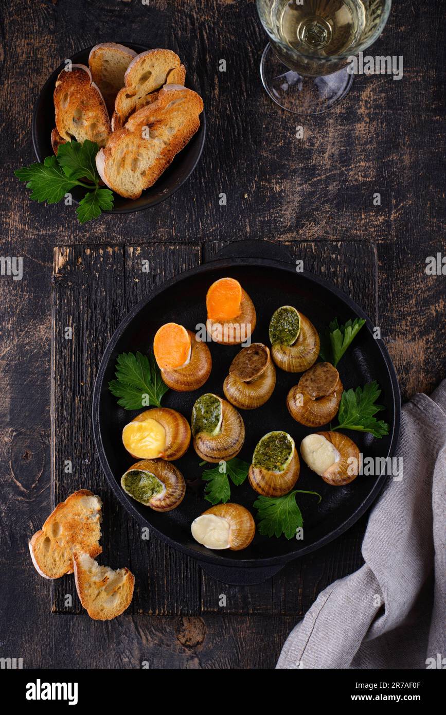 Baked snails Escargot with bread Stock Photo - Alamy