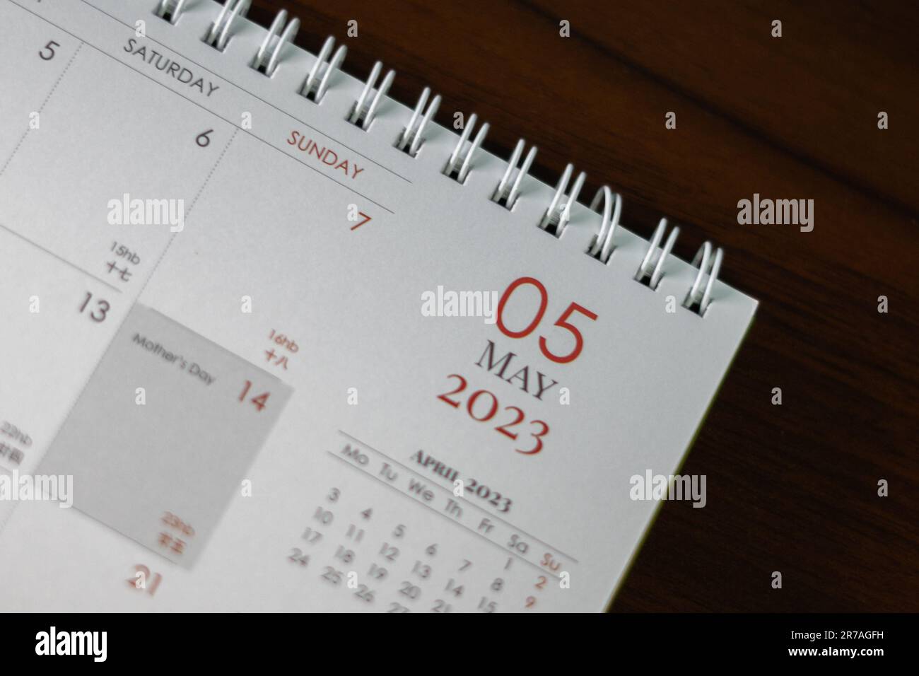 An opened calendar with a small calculator beside it Stock Photo