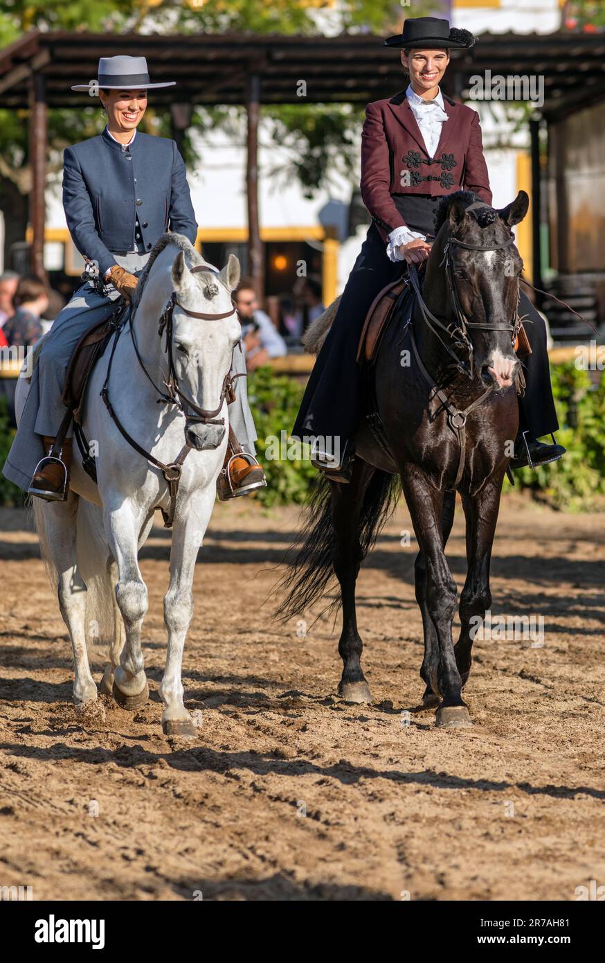 Europe, Portugal, Alentejo Region, Golega, Two Women riding Lusitano Horses and wearing Traditional Costume at the Golega Horse Fair 2022 Stock Photo