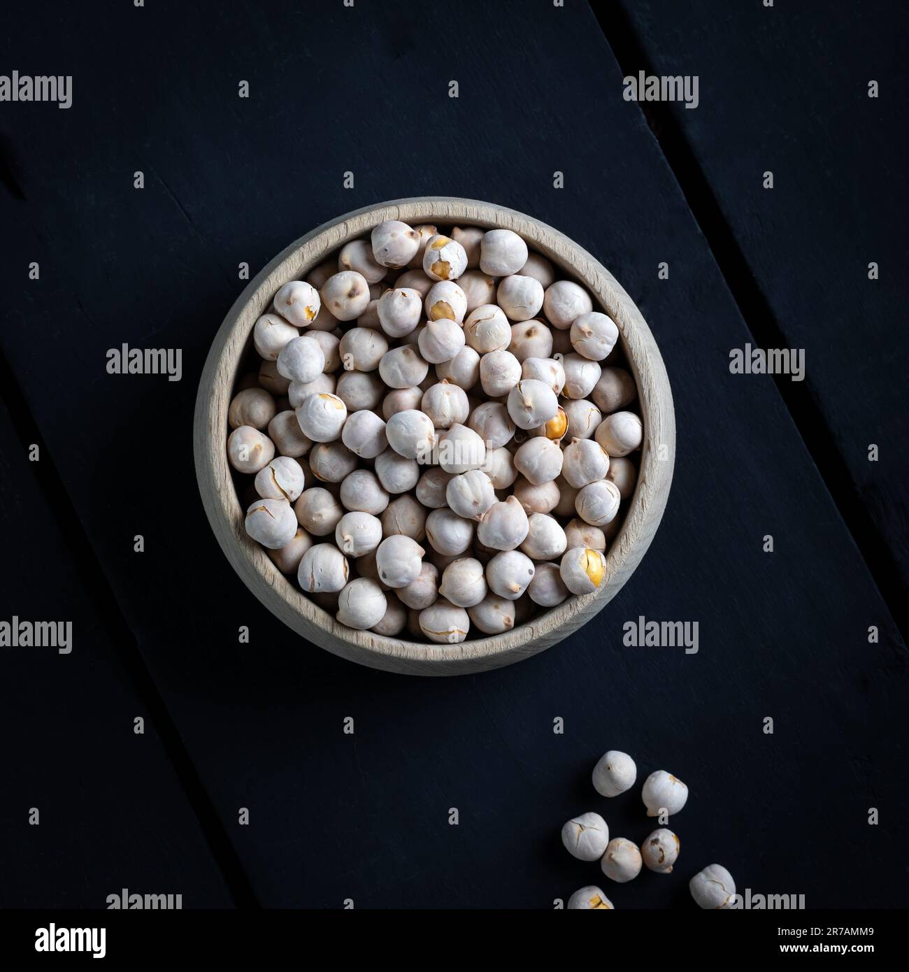 Roasted white chickpeas in wooden bowl, traditional Turkish nut on dark ...