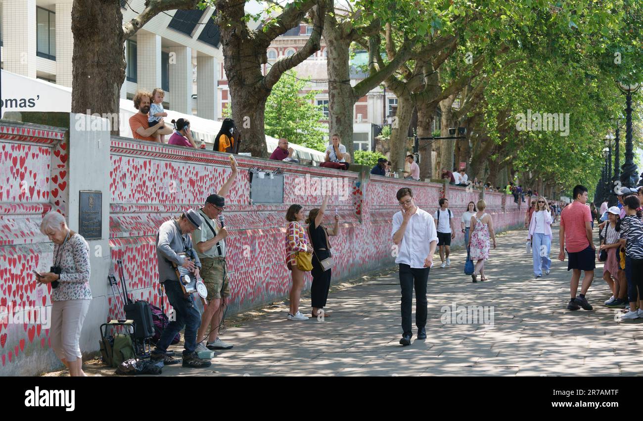 London, UK June 14th People relax outside in the sunshine. PICTURED: The Covid memorial wall along the cooler South Bank. The covid enquiry is underway, and temperatures reached 28C. Bridget Catterall AlamyLiveNews Stock Photo