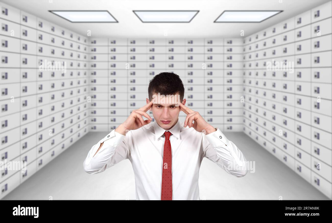 businessman thinking and standing in security safe room Stock Photo