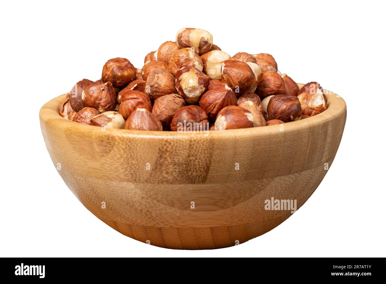 Hazelnut isolated on white background. Peeled hazelnuts in wooden bowl
