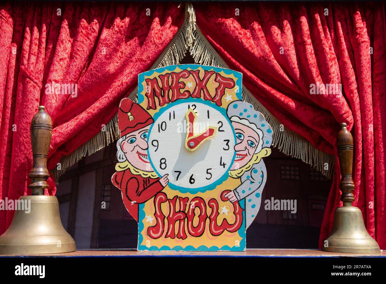 A clock to announce the next Punch & Judy Show Stock Photo