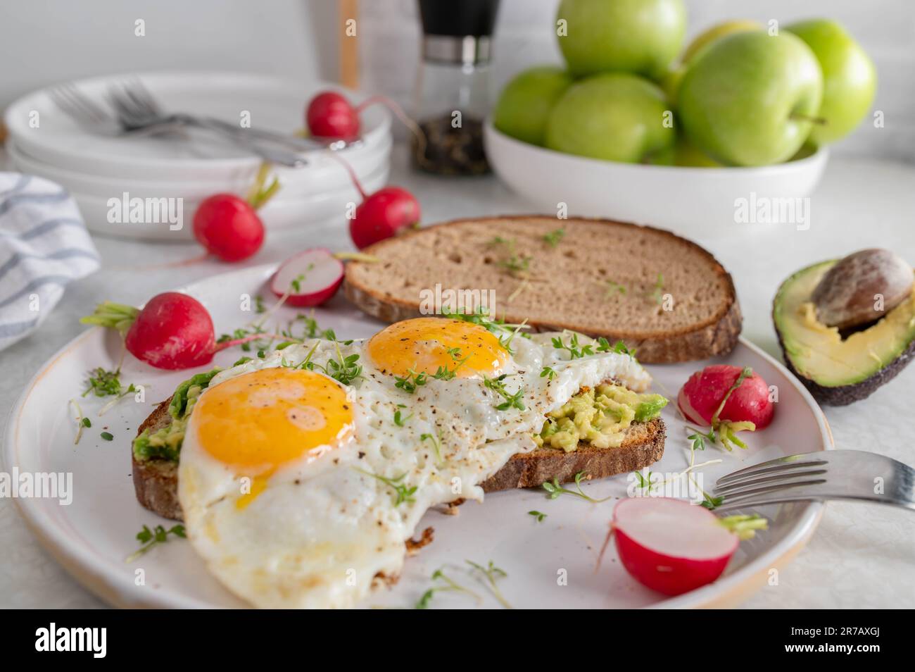Fried egg sandwich with avocado spread Stock Photo