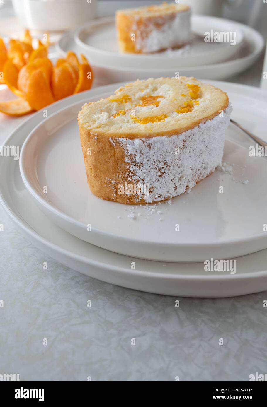 Slice of swiss roll with cream and mandarin oranges Stock Photo