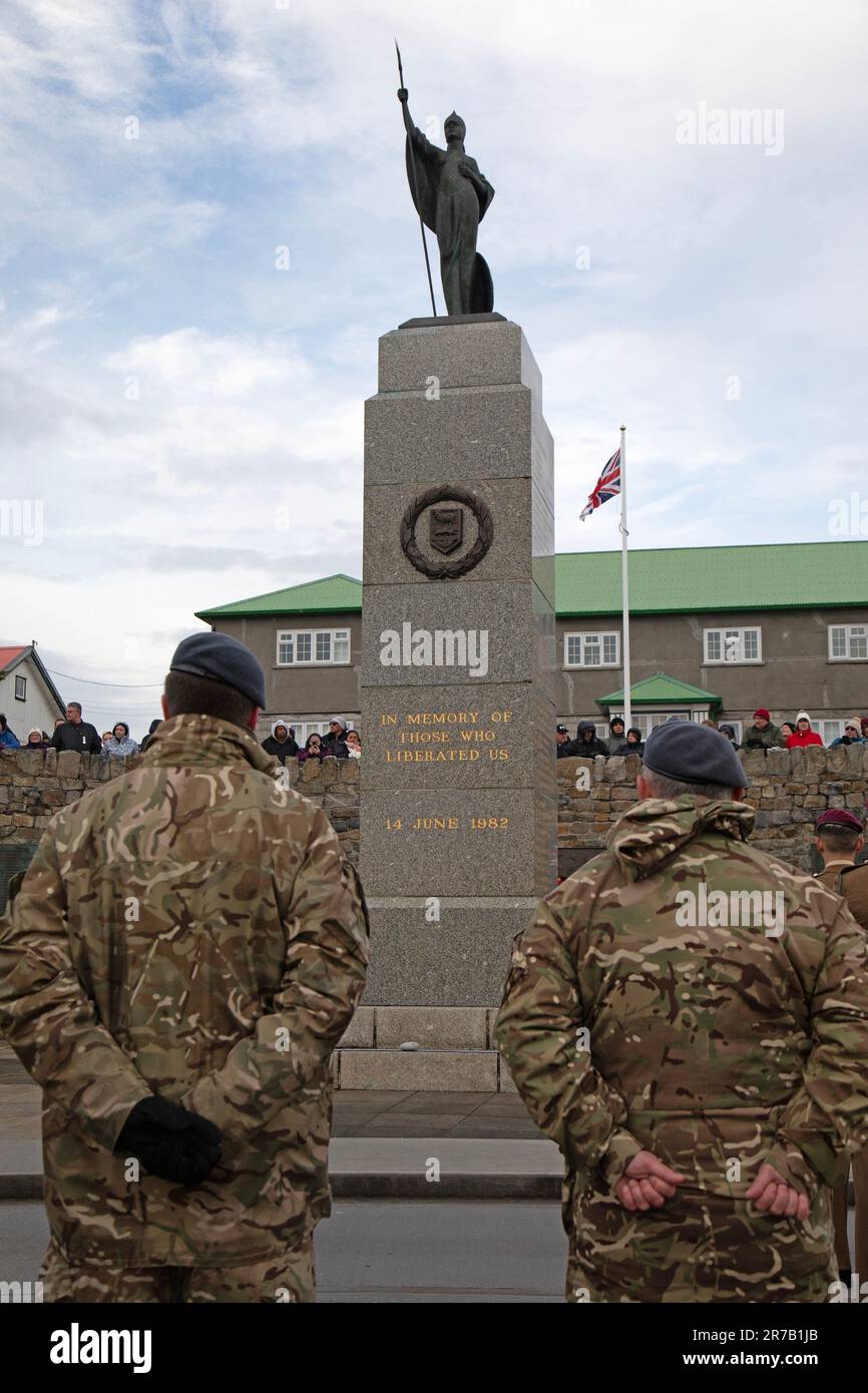14th June 2023. Stanley, Falkland Islands,  , On 14th June 1982, the British Forces marched in to Stanley in The Falkland Islands, liberating the town from the invasion of the Argentine Forces, thus ending the 74 day Falklands War. This date, 14th June, is celebrated every year in the Falkland islands, by a Celebration Day, and a day of thanks. It is also a Public Holiday. Two soldiers of the British Army face the 1982 Falklands War Memorial in Stanley during the thanksgiving service. Credit: Rob Carter/Alamy Live News Stock Photo