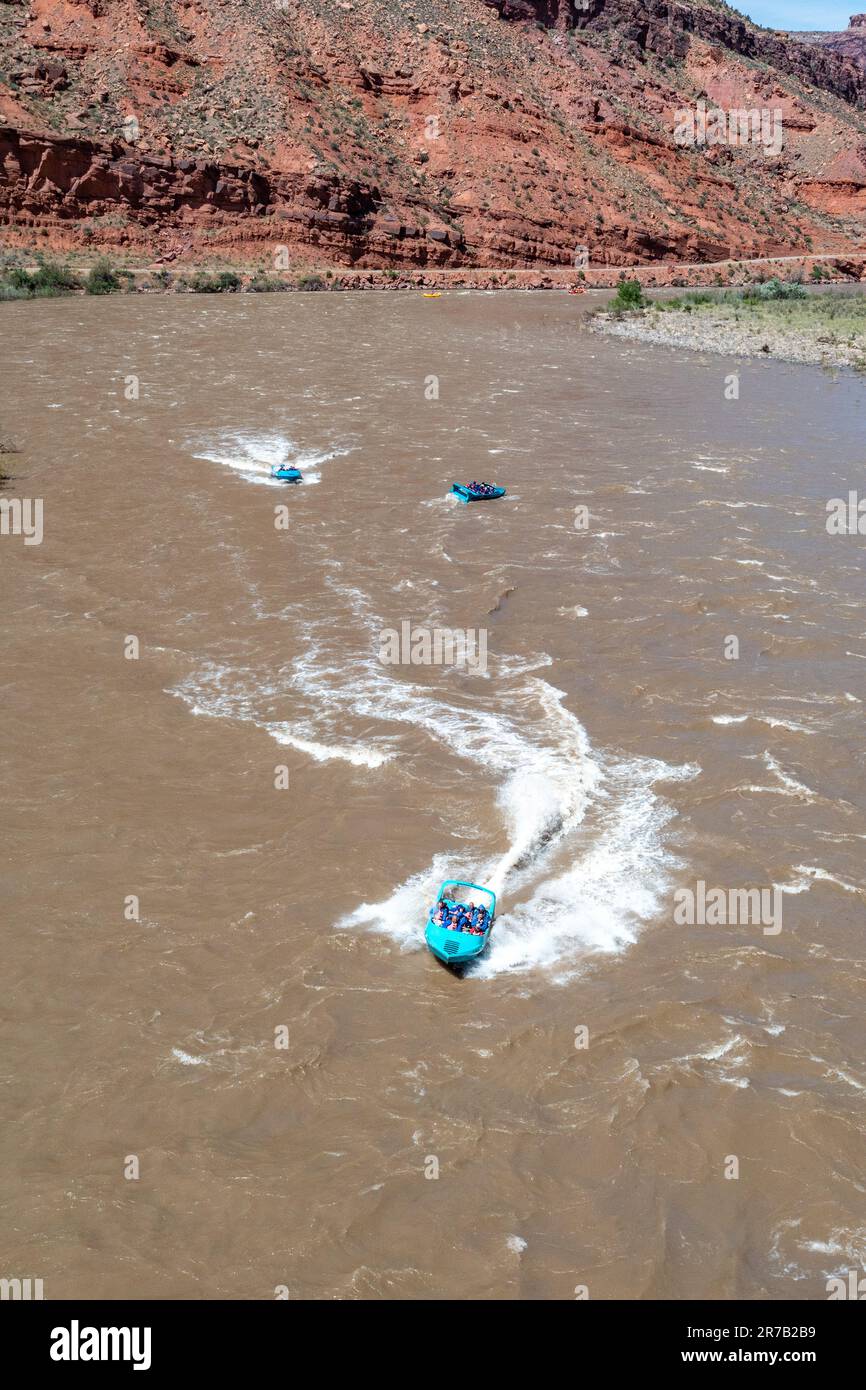 Tourists on a jet boat tour in White's Rapid on the Colorado River at high water.  Moab, Utah. Stock Photo