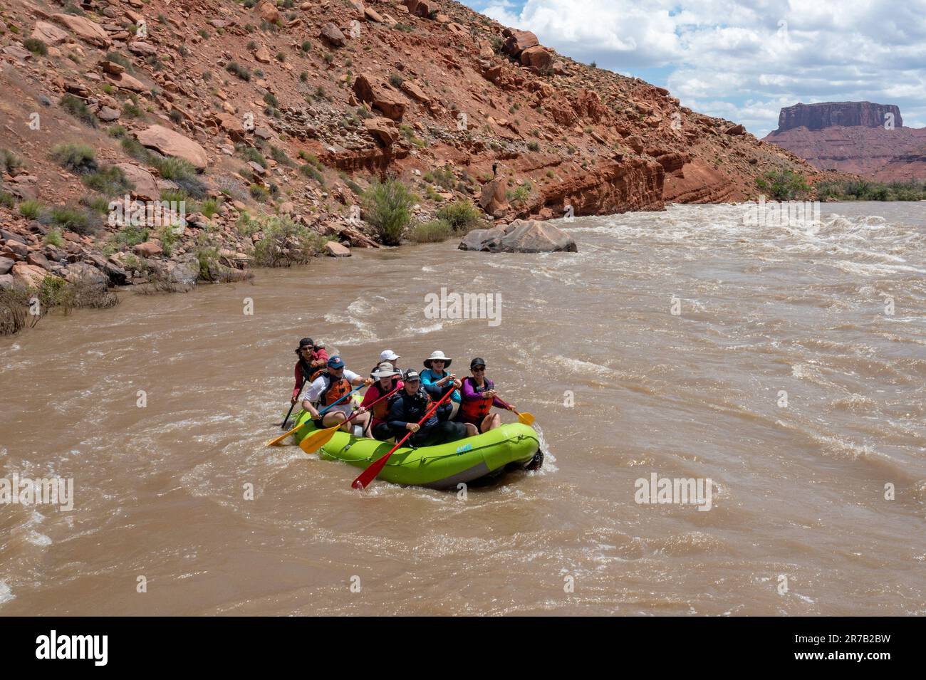 Tourists enjoy a rafting trip through the big waves in White's Rapid on the Colorado River at high water.  Moab, Utah. Stock Photo