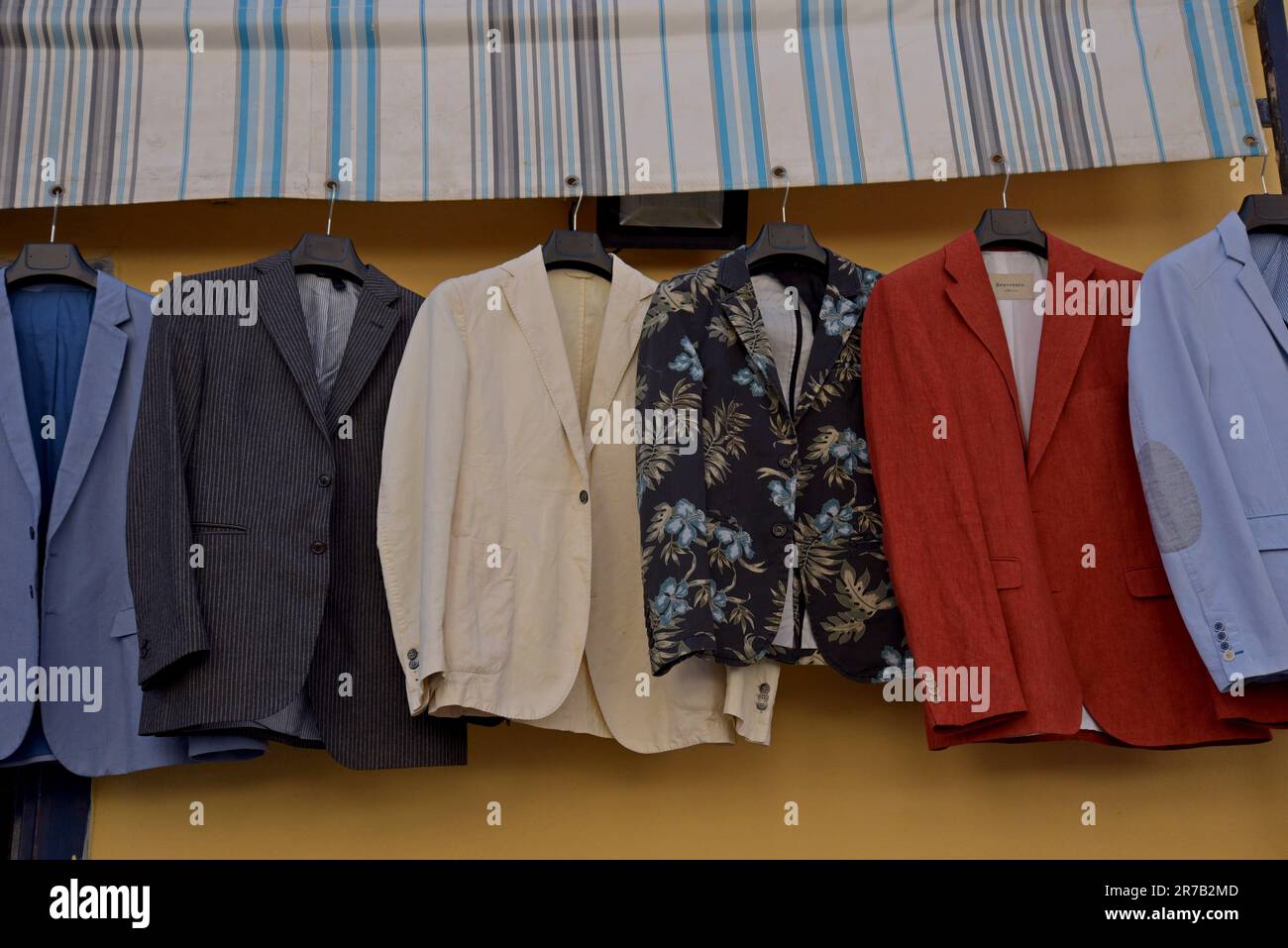 Colourful mens jackets on sale at the vintage and retro clothes market of Pugliano, in Ercolano, Naples, Italy Stock Photo