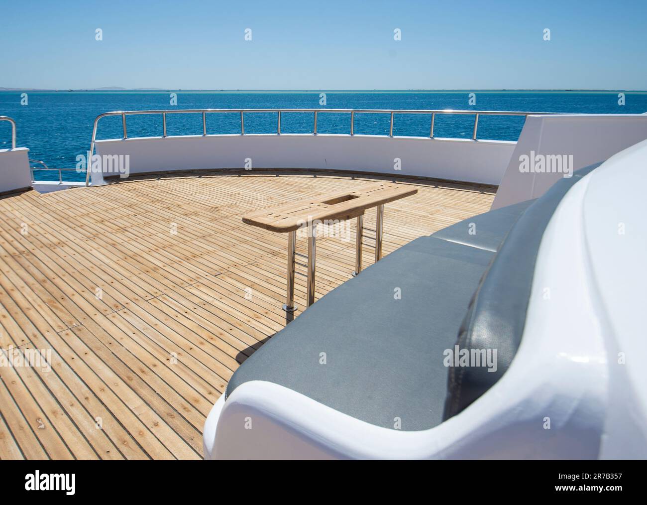 Teak bow deck of a large luxury motor yacht with chairs sofa table and