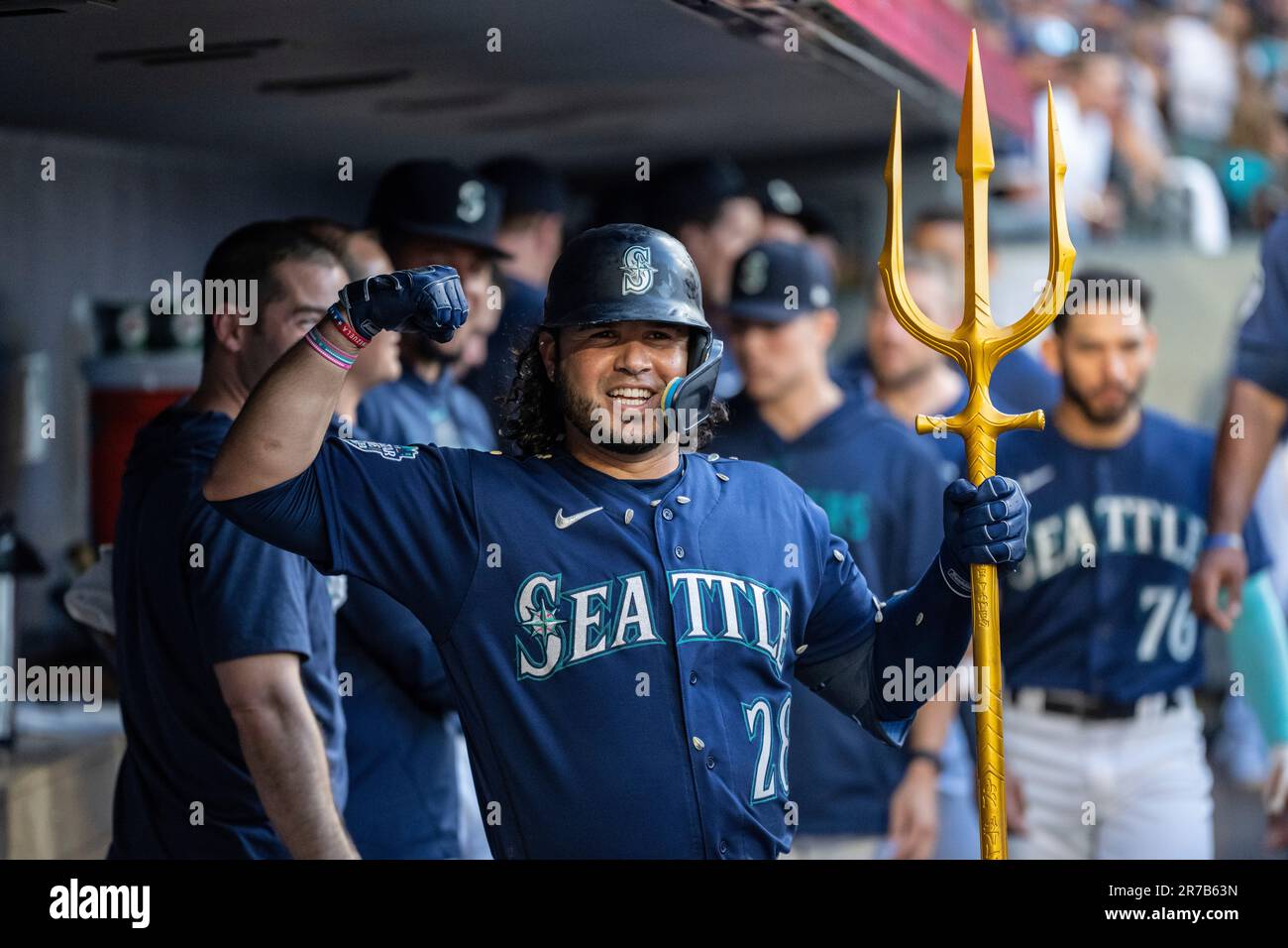 Seattle Mariners' Eugenio Suarez celebrates in the dugout after hitting