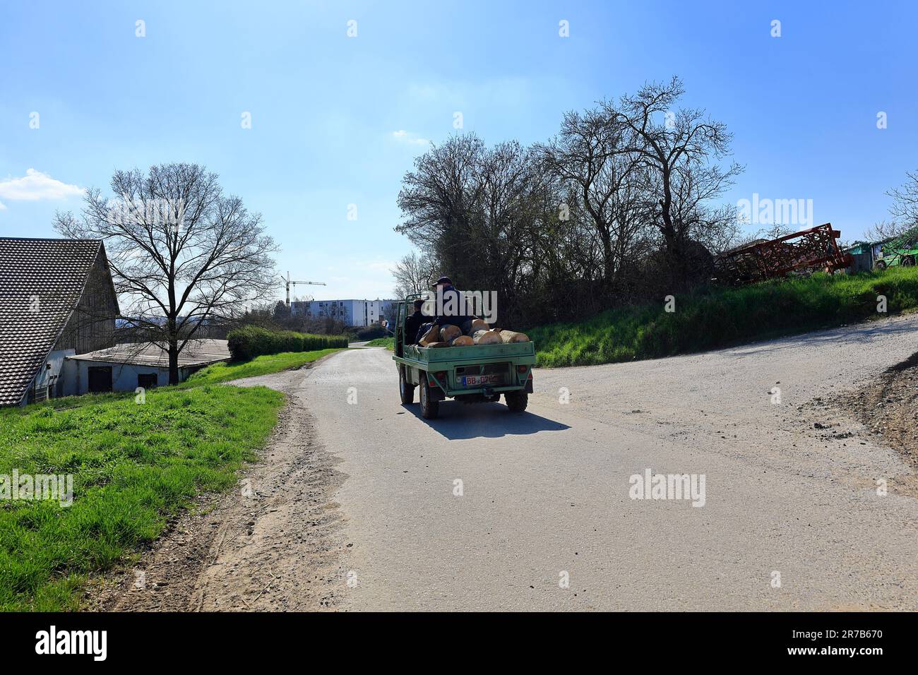 Small transporter with firewood and one person on the loading area Stock Photo