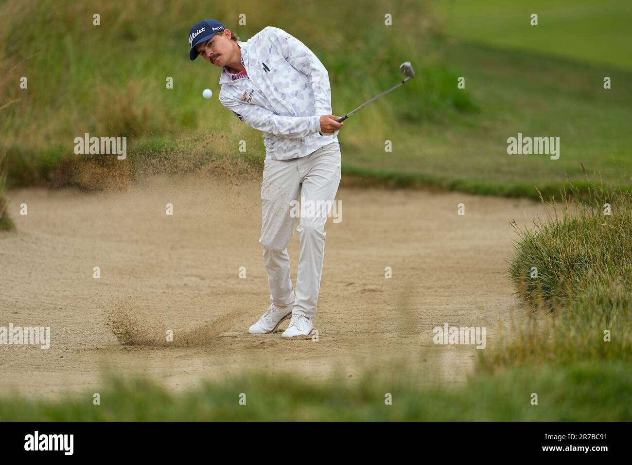 Carson Young hits from the bunker on the eighth hole during a practice