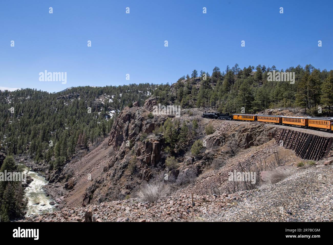 Durango & Silverton Narrow Gauge Railroad transporting passengers through the mountain landscape of the San Juan National Forest in Colorado. Stock Photo