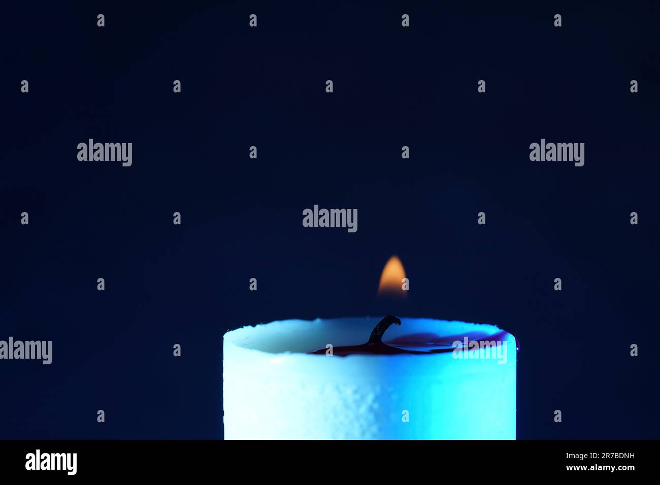 candle with smoke and flame photographed in the studio with color foils