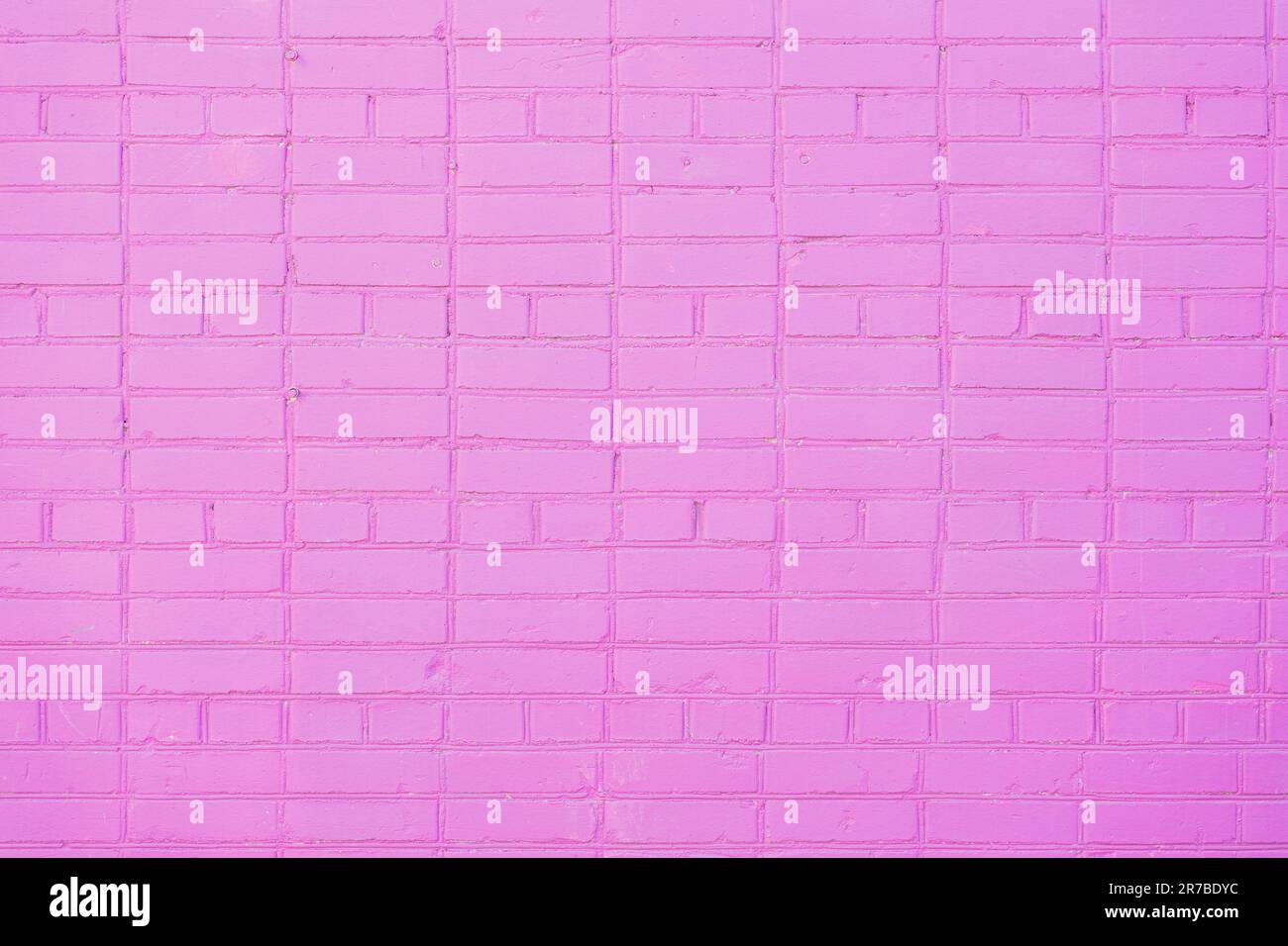 Wall background. Brickwork pattern, stonework interior stone, pink purple brick design stack. Stock Photo