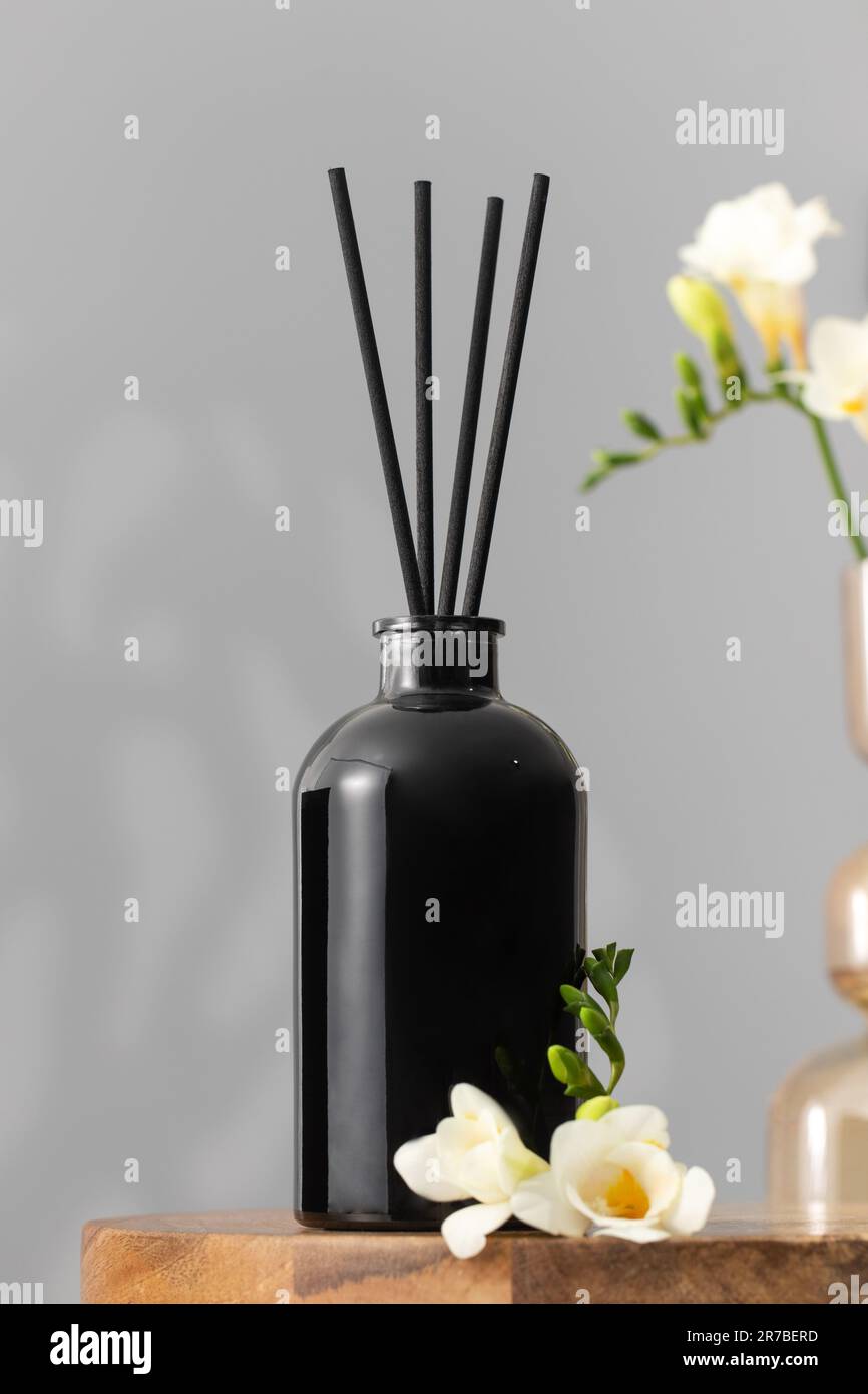 Black glass diffuser with the scent of flowers. The concept of home
