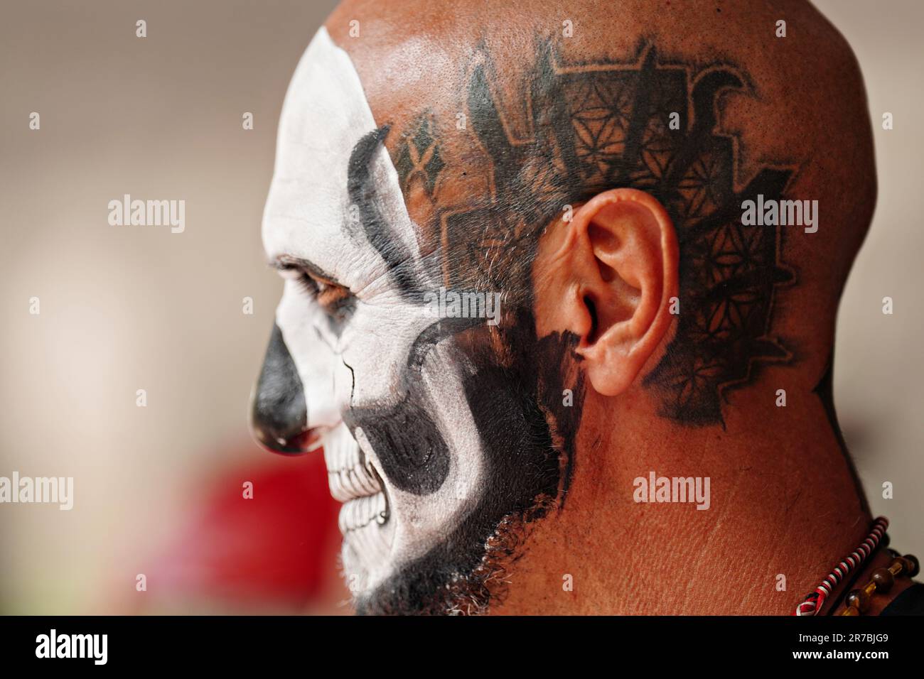 A bald man wearing skeleton face paint marches in the Grand Parade celebration for the Day of the Dead holiday on Paseo de la Reforma, October 29, 2022 in Mexico City, Mexico. Stock Photo