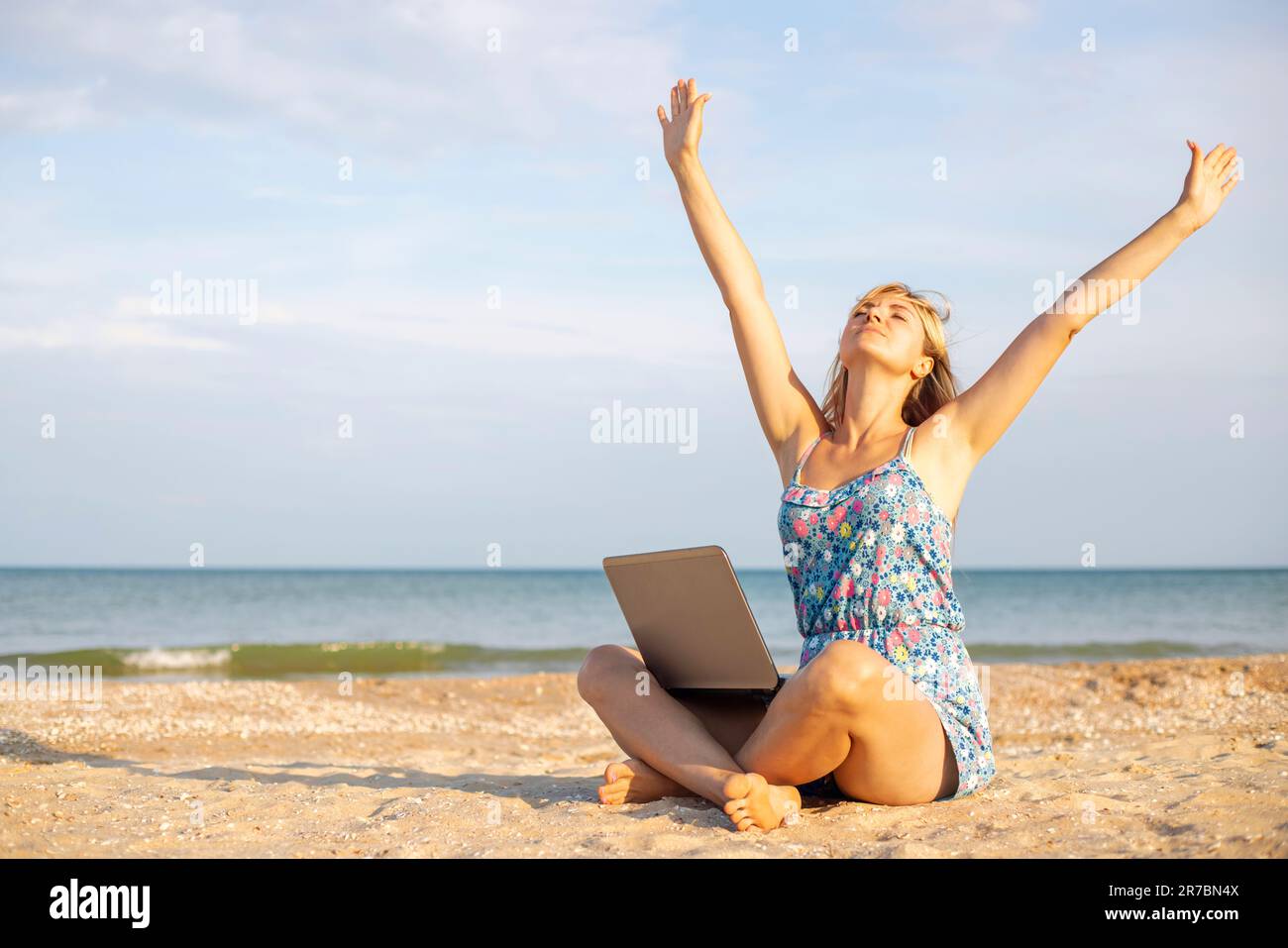 Beautiful young woman working with laptop on the tropical beach Stock ...