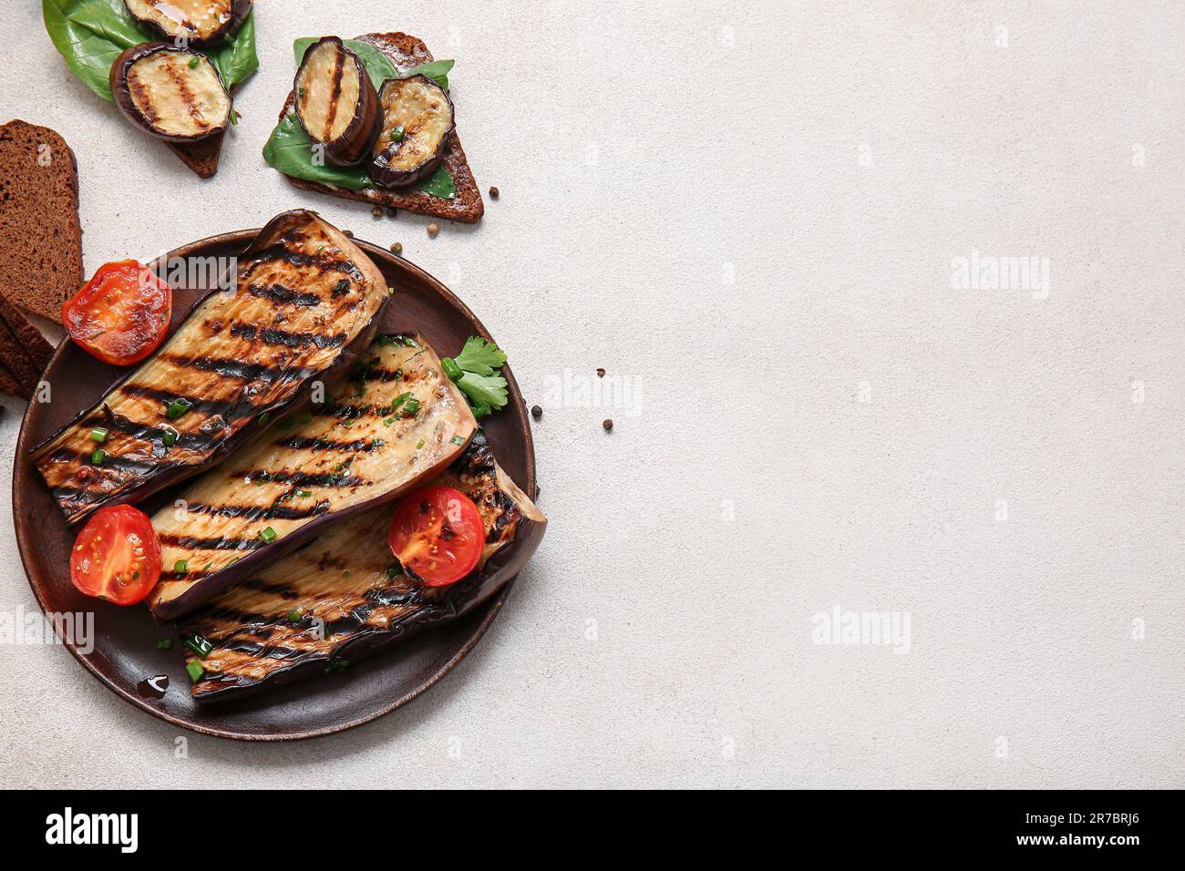 Composition with delicious grilled eggplants on light background Stock Photo