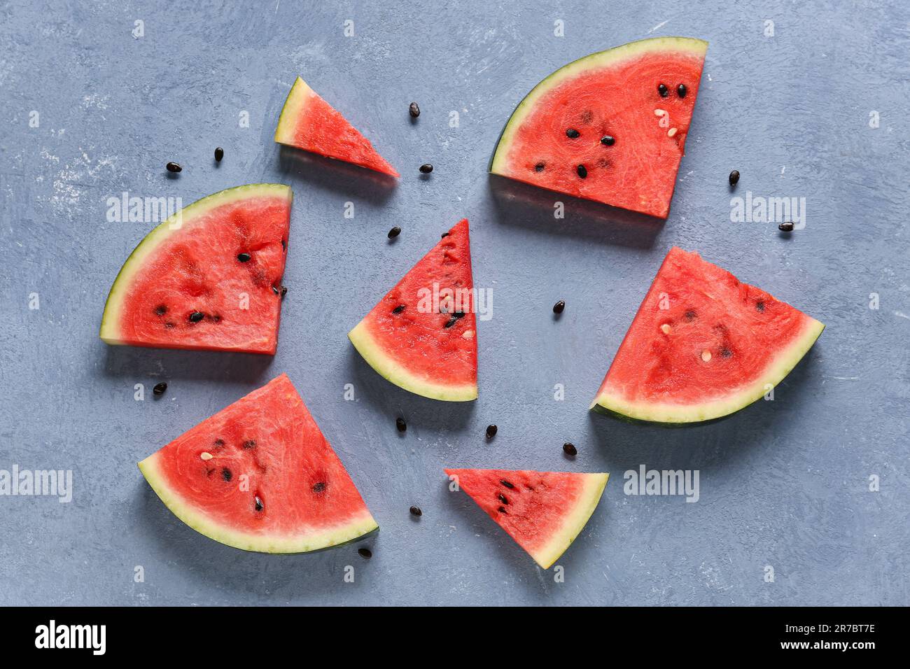 Pieces of fresh watermelon on blue background Stock Photo - Alamy