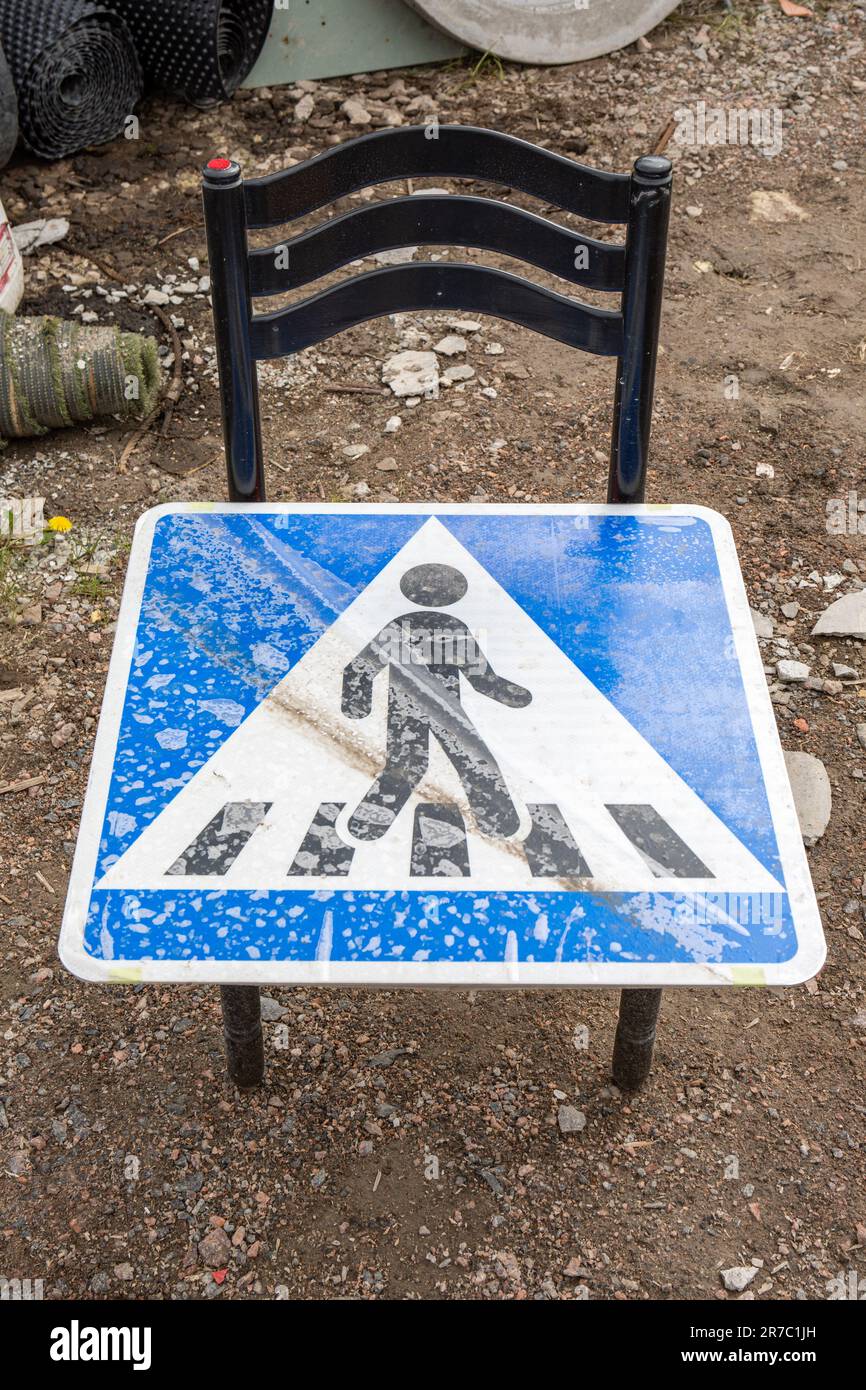 Gender neutral crosswalk or pedestrian crossing sign on a chair Stock Photo
