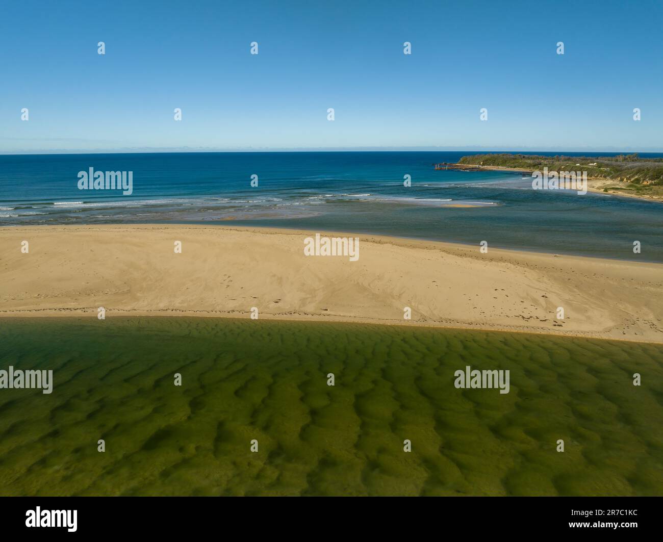 Blue sky daytime coast views over the sea and the Wallagaraugh River at Mallacoota, Victoria, Australia Stock Photo