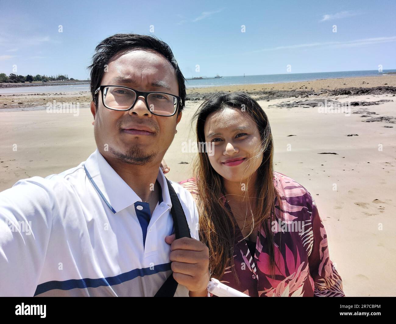 A smiling man and woman pose together while taking a selfie Stock Photo