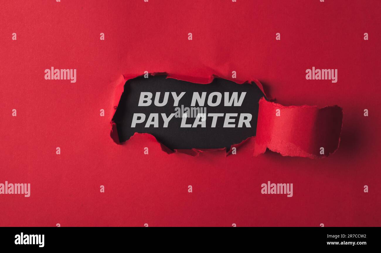 text buy now pay later on torn paper Stock Photo Alamy