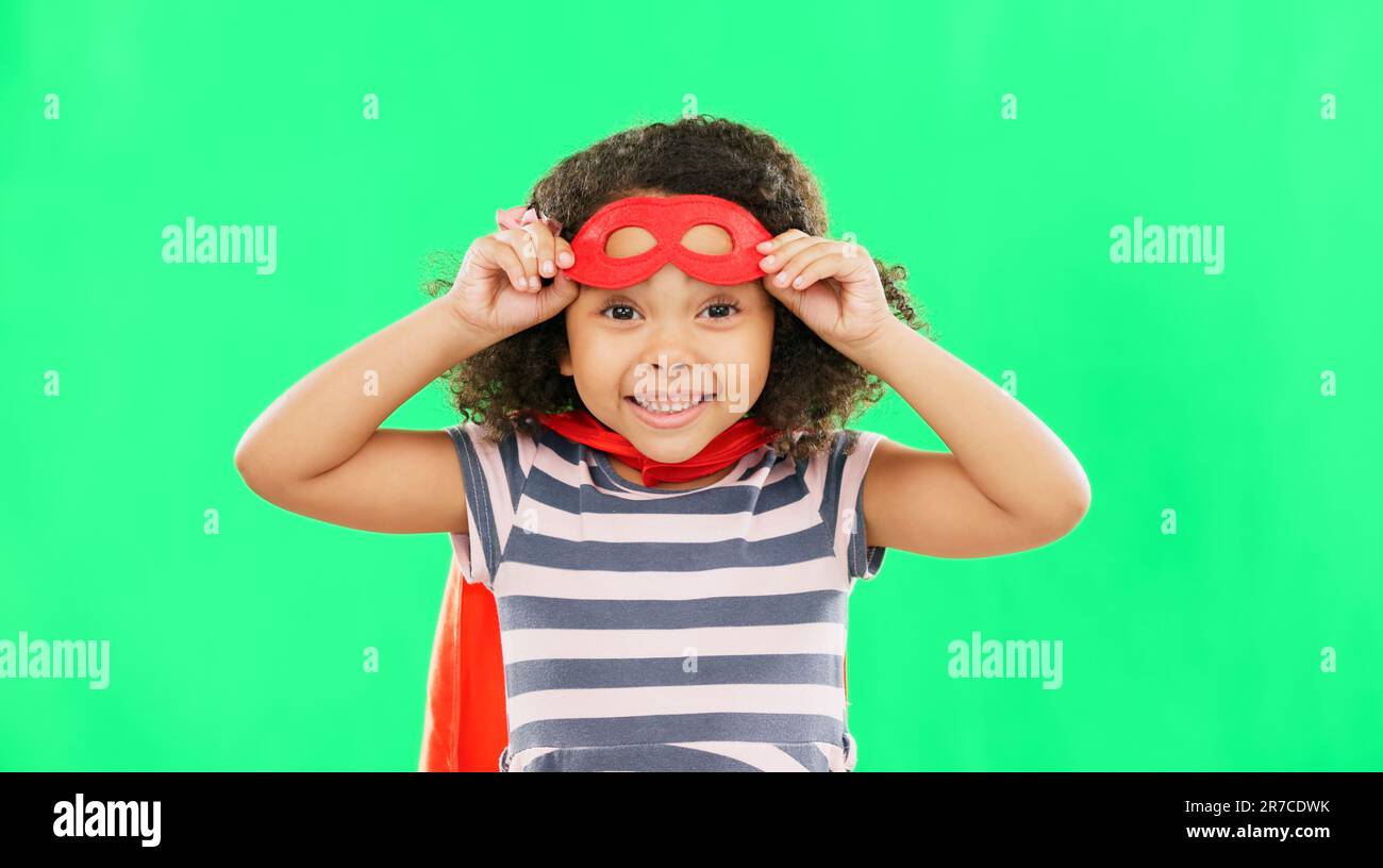 Happy child, superhero and portrait on green screen with a smile to