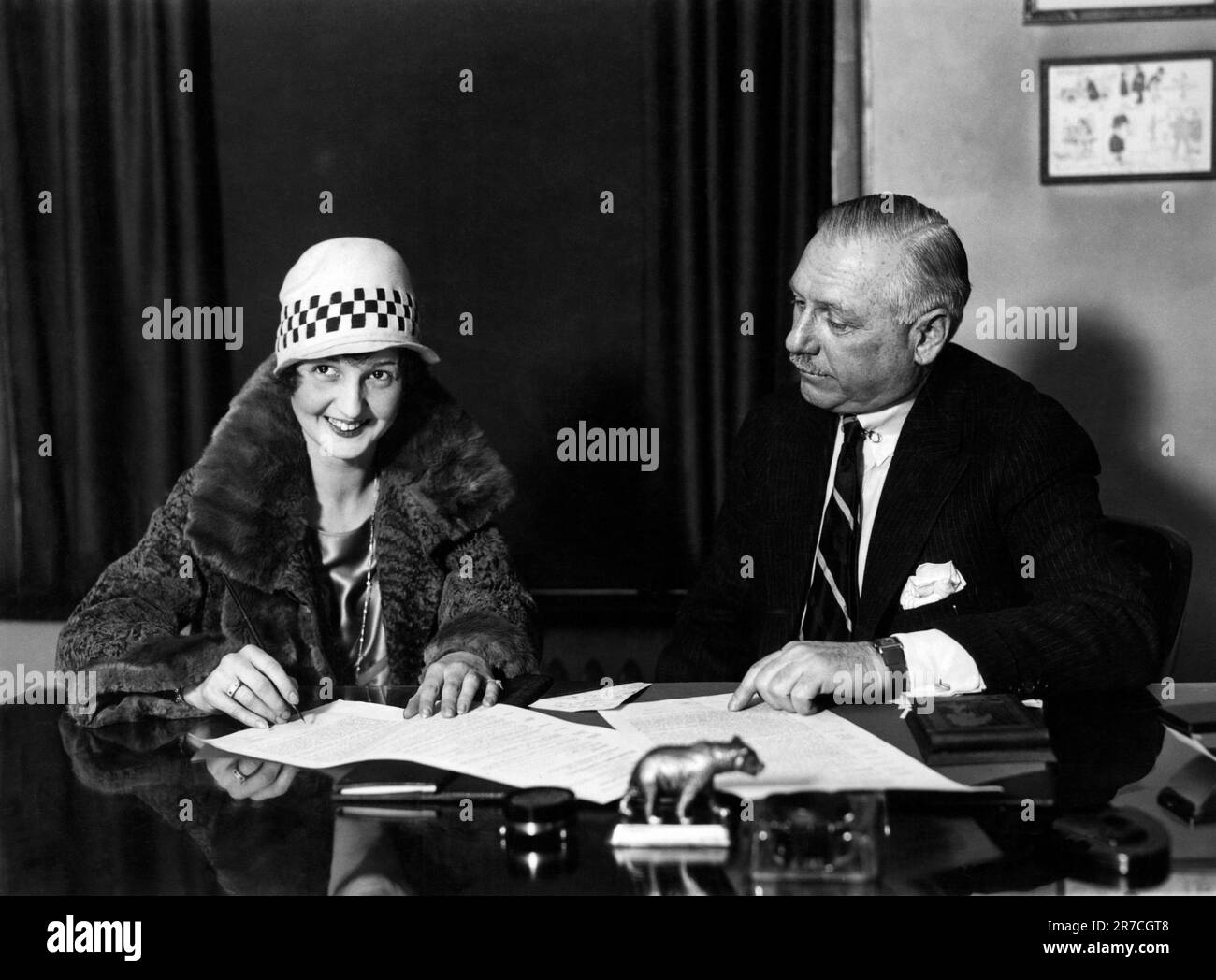 New York, New York,  January, 1927 Louise Hunter, the youngest operatic prima donna at the Metropolitan Opera House, signs a five year contract with playwright, songwriter and theater manager Arthur Hammerstein. Stock Photo