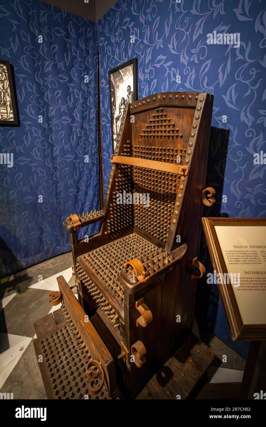 Interrogation Chair (or Iron Chair) - Instrument of Torture at Inquisition Museum in the Palace of the Forgotten - Granada, Spain Stock Photo