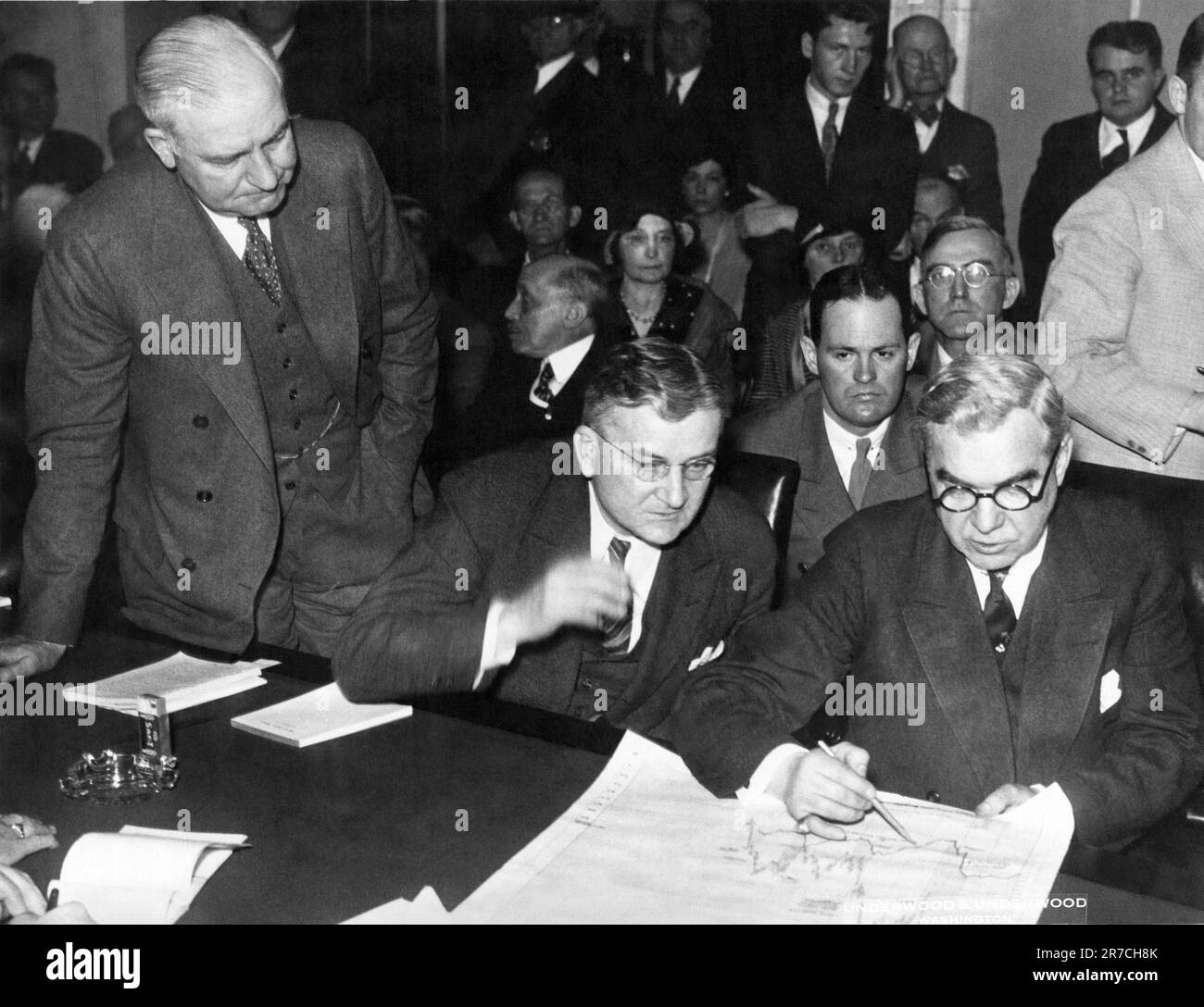 Washington, D.C.:   April 22, 1932 Members of the Senate Banking Committee are investigaitng the stock market. Here Senator Carey of Wyoming at left and Senator Blaine of Wisconsin question Mathew Brush, prominent Wall Atreet operator,  right, about short selling. Stock Photo